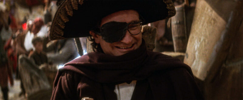 Peter, amused by the street musicians as they start to sing "Low Below"