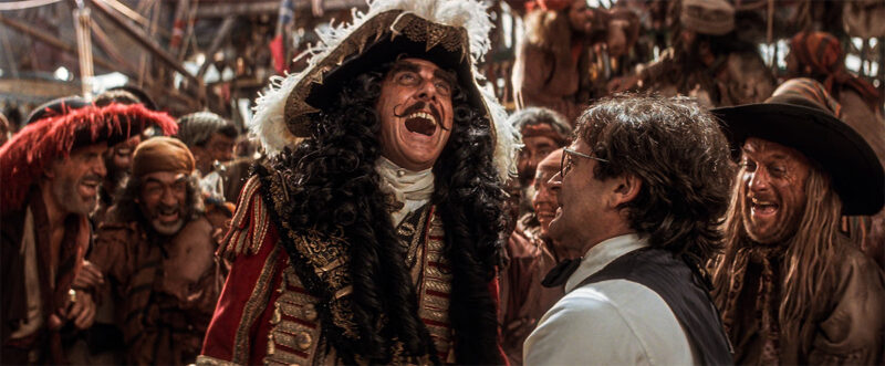 Captain Hook humiliates Peter, making his crew laugh.