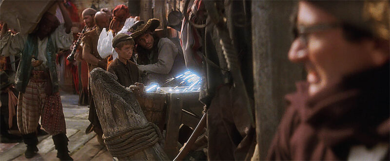 A Lost Boy prisoner being forced to learn from a pirate.