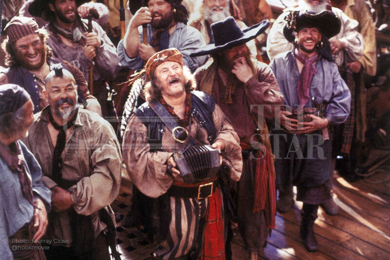 Tickles playing the concertina as the crowd cheers for Captain Hook.