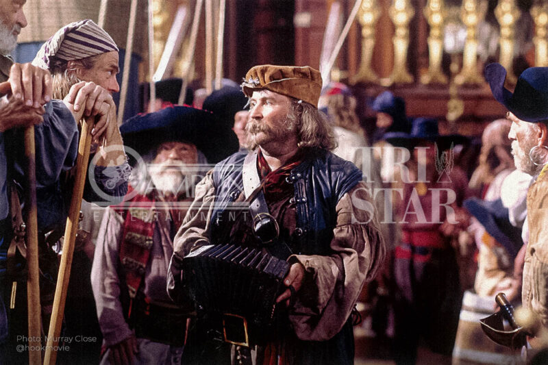 Tickles playing the concertina as the crowd cheers for Captain Hook.